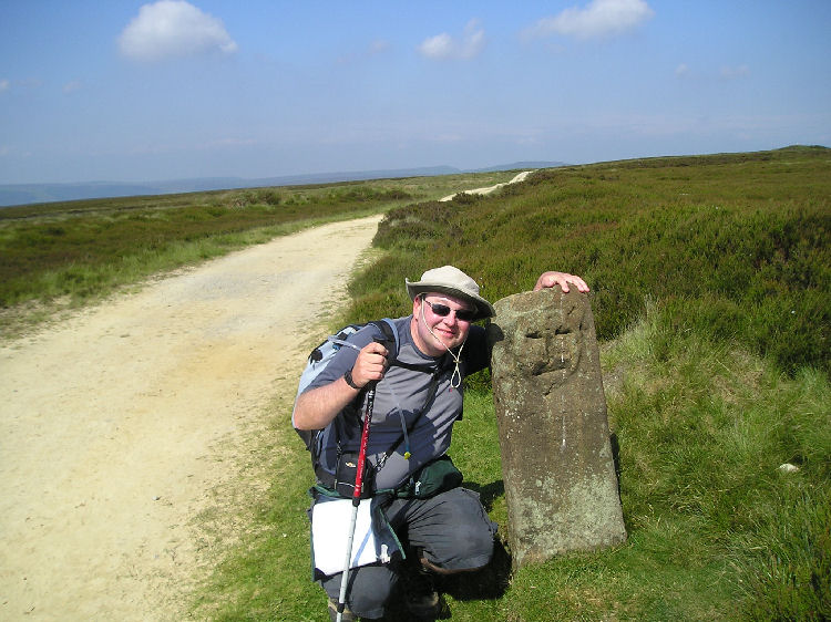 The smiley face boundary stone on the track over Urra Moor